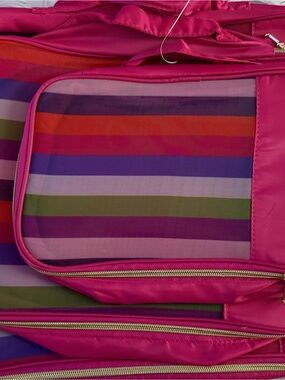 Isaac Mizrahi packing cubes with a pink and striped design.